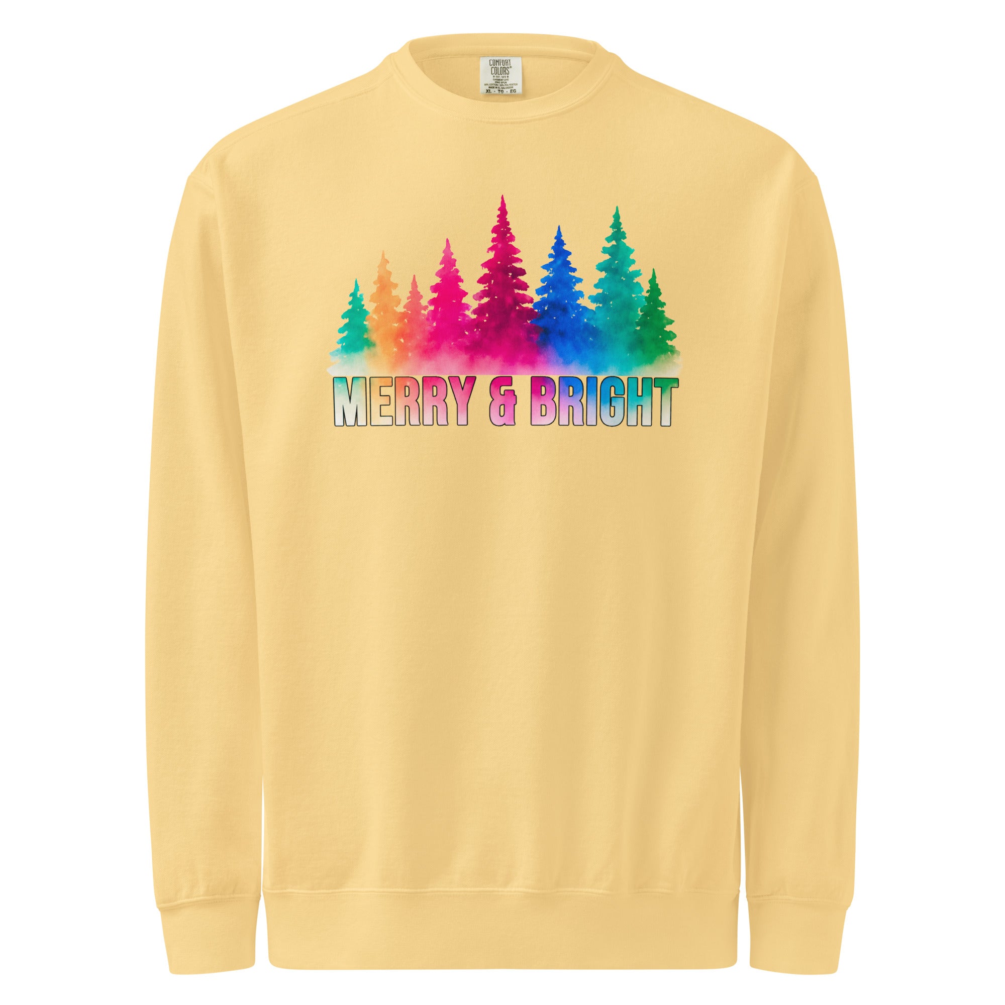 A yellow sweatshirt with a graphic design featuring a line of colorful trees and the text "MERRY & BRIGHT" in a rainbow color scheme.